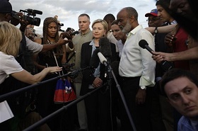 Haiti's President Rene Preval, right, answers questions from the press as U.S. Secretary of State Hillary Rodham Clinton, center, looks on in Port-au-Prince, Haiti, Saturday, Jan. 16, 2010.  Preval and Clinton met to discuss the current state of emergency in Haiti after Tuesday's deadly earthquake. (AP Photo/Julie Jacobson)