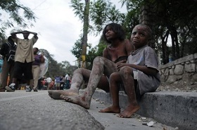 Injured people sit along Delmas road the day after an earthquake struck Port-au-Prince, Haiti, Wednesday, Jan. 13, 2010.  A 7.0-magnitude earthquake hit Haiti on Tuesday. AP Photo/Jorge Cruz